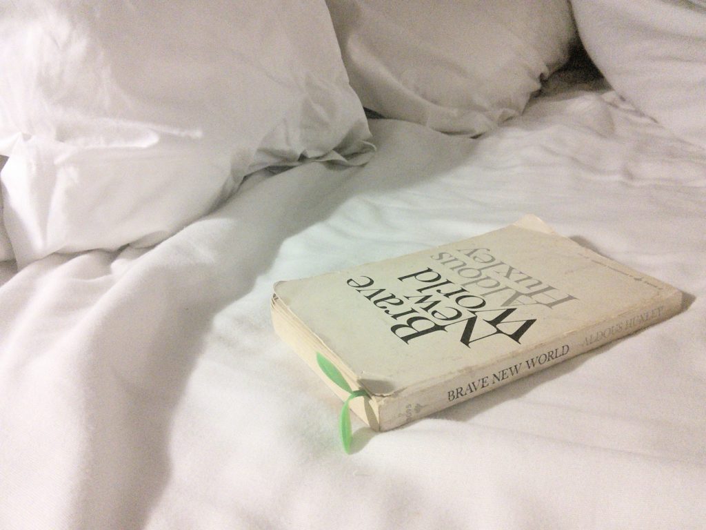 white bed linens, with book